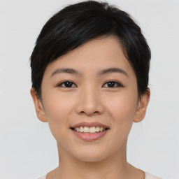 Joyful asian young-adult female with short  brown hair and brown eyes