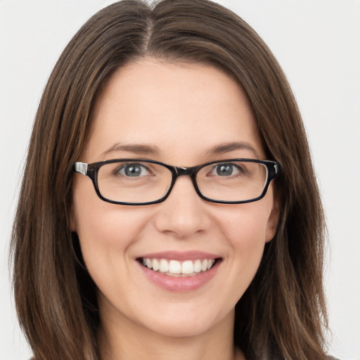 Joyful white young-adult female with long  brown hair and green eyes