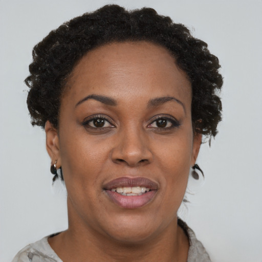 Joyful black adult female with short  brown hair and brown eyes