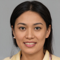 Joyful latino young-adult female with medium  brown hair and brown eyes