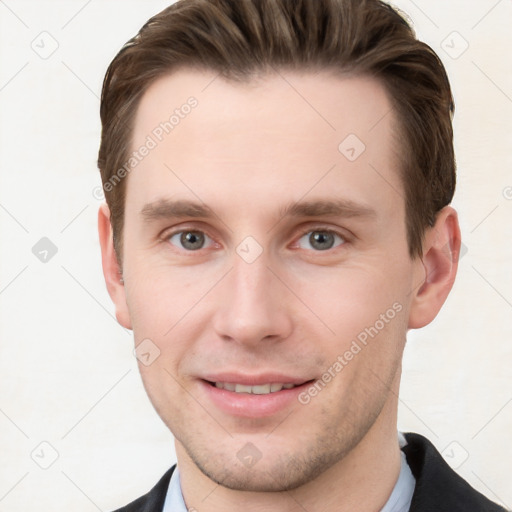 Joyful white young-adult male with short  brown hair and grey eyes