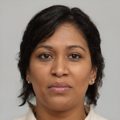 Joyful black adult female with medium  brown hair and brown eyes