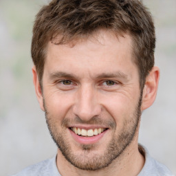 Joyful white adult male with short  brown hair and brown eyes