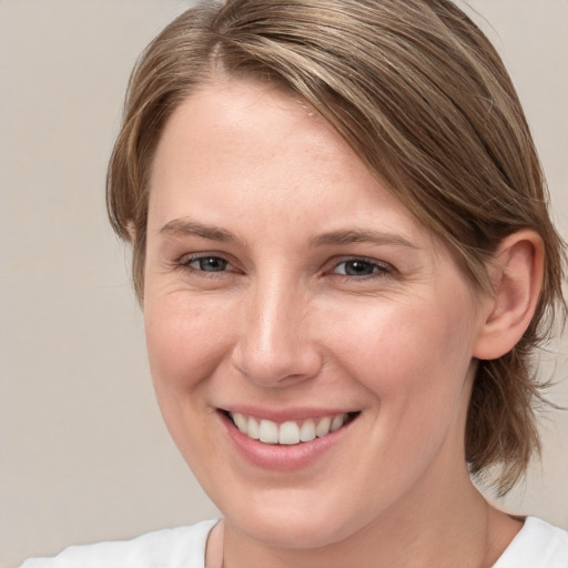 Joyful white young-adult female with medium  brown hair and brown eyes