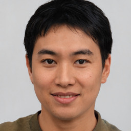 Joyful asian young-adult male with short  brown hair and brown eyes