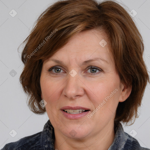 Joyful white adult female with medium  brown hair and blue eyes