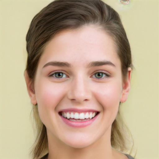 Joyful white young-adult female with long  brown hair and green eyes