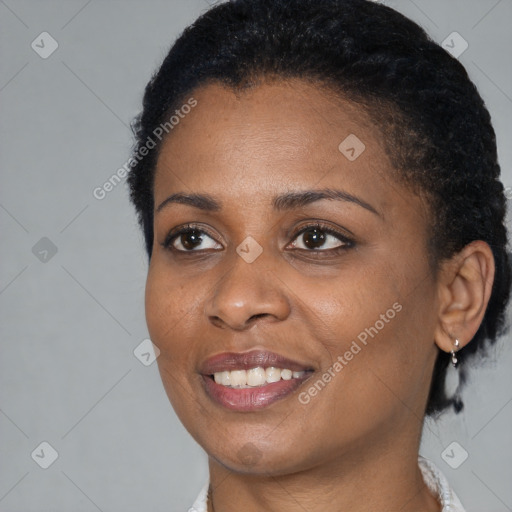 Joyful black young-adult female with short  black hair and brown eyes