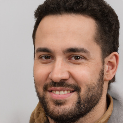 Joyful white adult male with short  brown hair and brown eyes