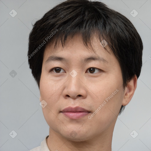 Joyful asian young-adult male with short  brown hair and brown eyes