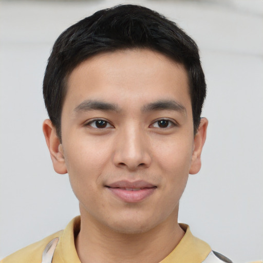 Joyful asian young-adult male with short  brown hair and brown eyes