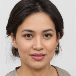 Joyful asian young-adult female with medium  brown hair and brown eyes