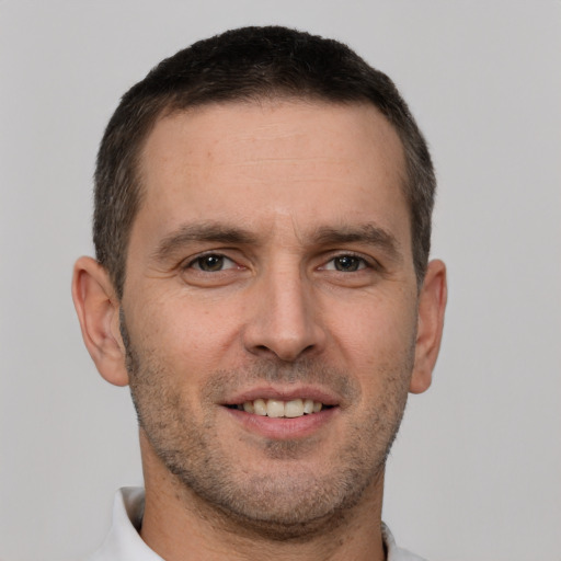 Joyful white young-adult male with short  brown hair and brown eyes