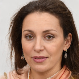 Joyful white adult female with long  brown hair and brown eyes