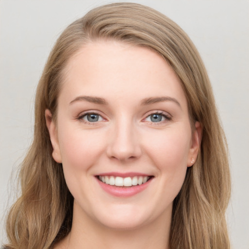 Joyful white young-adult female with long  brown hair and blue eyes