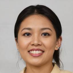 Joyful asian young-adult female with medium  brown hair and brown eyes