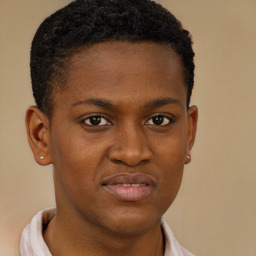 Joyful black young-adult male with short  brown hair and brown eyes