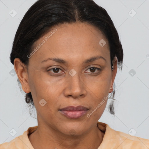 Joyful black adult female with medium  brown hair and brown eyes