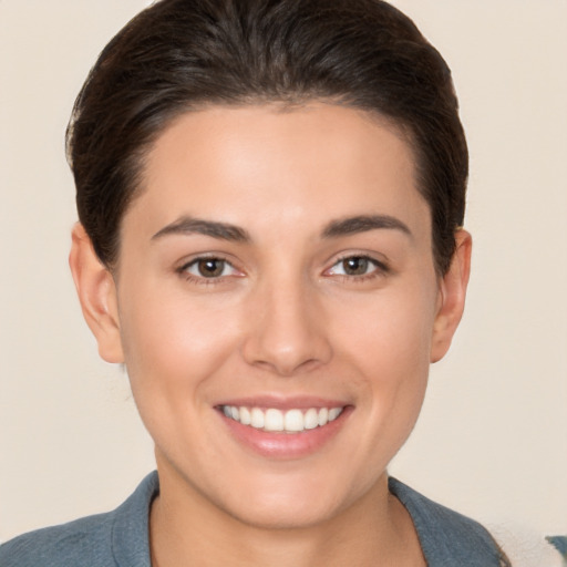 Joyful white young-adult female with short  brown hair and brown eyes