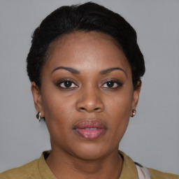 Joyful black young-adult female with short  brown hair and brown eyes