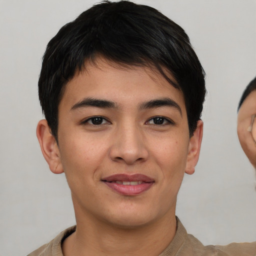 Joyful asian young-adult male with short  brown hair and brown eyes