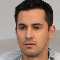 Neutral white young-adult male with short  black hair and brown eyes