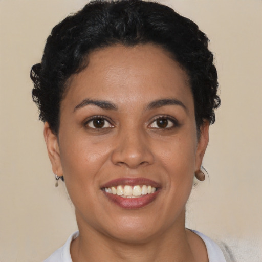 Joyful latino young-adult female with short  brown hair and brown eyes