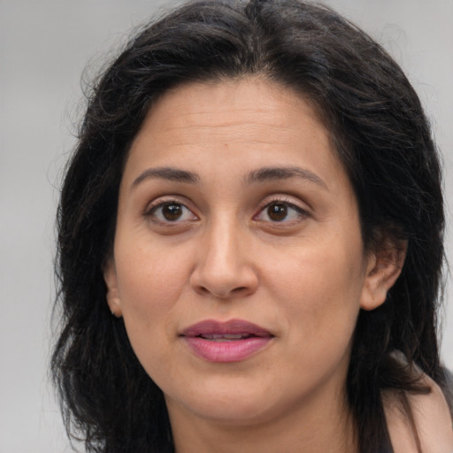 Joyful white adult female with long  brown hair and brown eyes