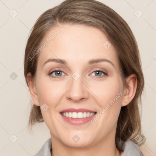 Joyful white young-adult female with medium  brown hair and grey eyes