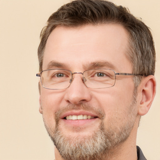 Joyful white adult male with short  brown hair and brown eyes