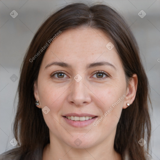 Joyful white adult female with long  brown hair and brown eyes