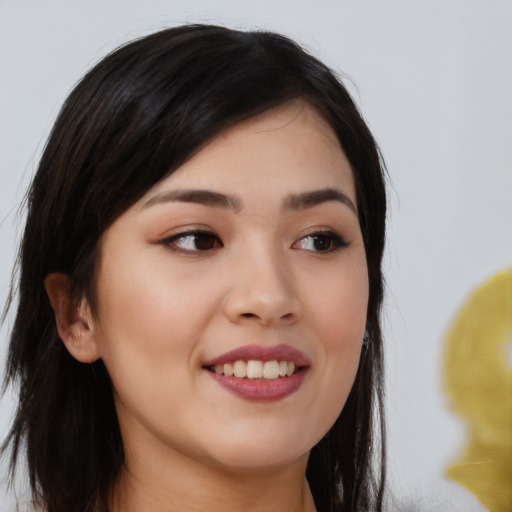 Joyful asian young-adult female with long  black hair and brown eyes