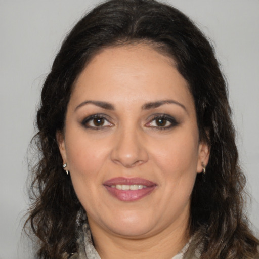 Joyful white adult female with medium  brown hair and brown eyes