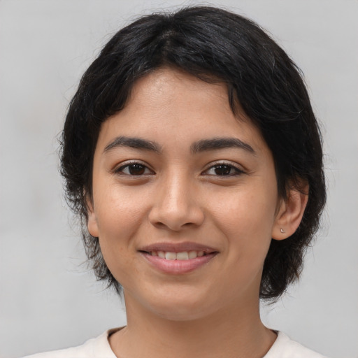 Joyful latino young-adult female with medium  black hair and brown eyes