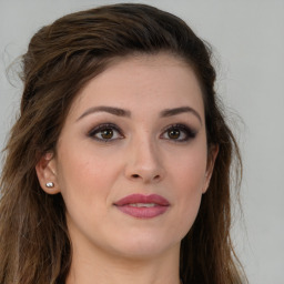 Joyful white young-adult female with long  brown hair and green eyes