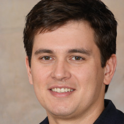 Joyful white young-adult male with short  brown hair and brown eyes