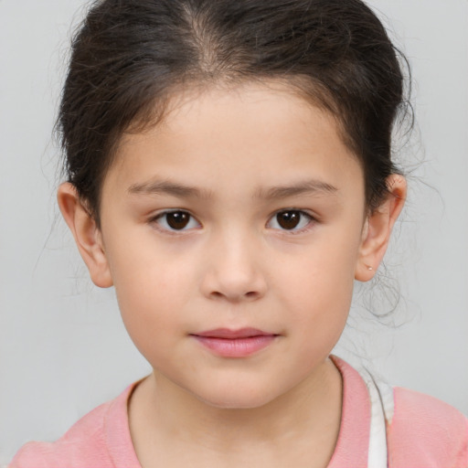 Joyful white child female with short  brown hair and brown eyes