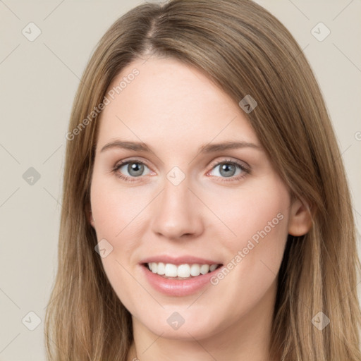 Joyful white young-adult female with long  brown hair and green eyes