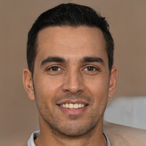 Joyful white young-adult male with short  brown hair and brown eyes