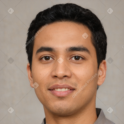 Joyful latino young-adult male with short  black hair and brown eyes