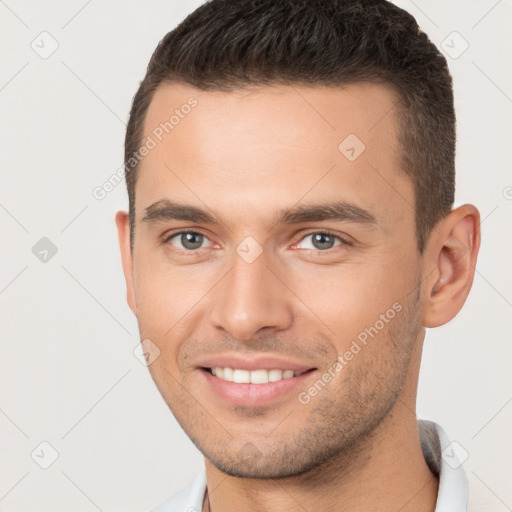 Joyful white young-adult male with short  brown hair and brown eyes