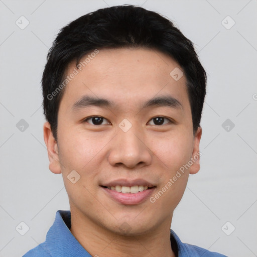 Joyful asian young-adult male with short  black hair and brown eyes