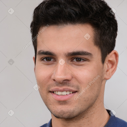 Joyful white young-adult male with short  black hair and brown eyes