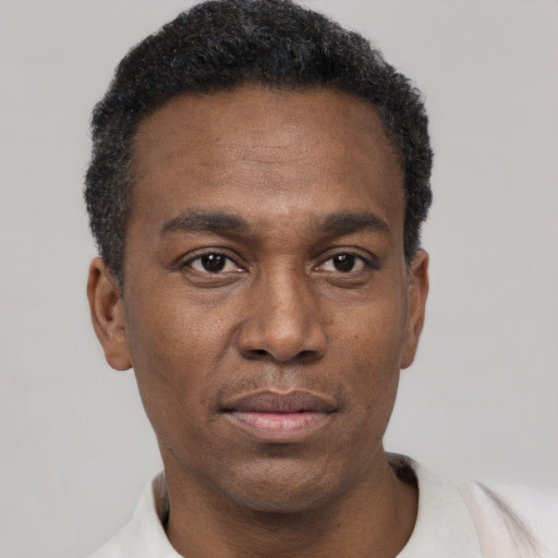 Neutral black young-adult male with short  black hair and brown eyes