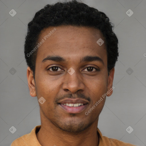 Joyful black young-adult male with short  brown hair and brown eyes