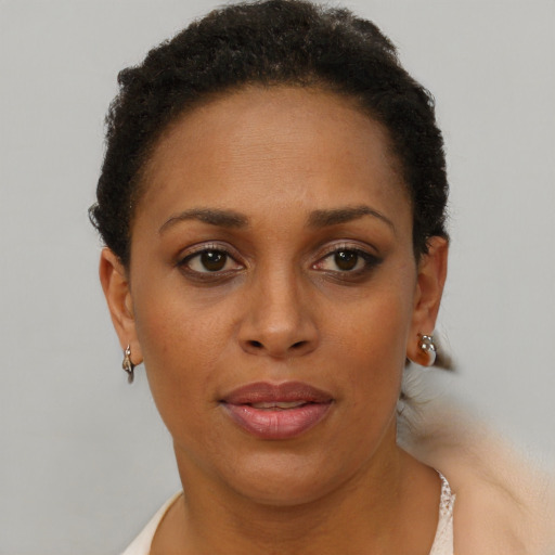 Joyful black adult female with short  brown hair and brown eyes