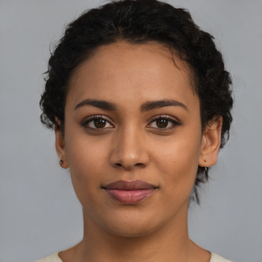 Joyful latino young-adult female with short  brown hair and brown eyes