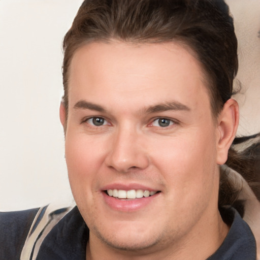 Joyful white young-adult male with short  brown hair and brown eyes