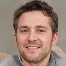 Joyful white adult male with short  brown hair and brown eyes