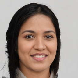 Joyful latino young-adult female with long  brown hair and brown eyes